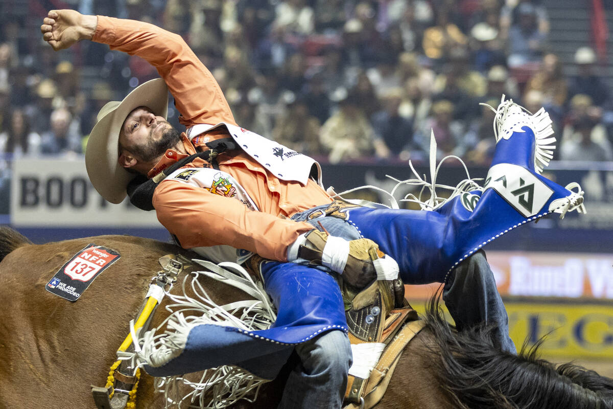 Taylor Broussard competes in the bareback riding event during day nine of the National Finals R ...