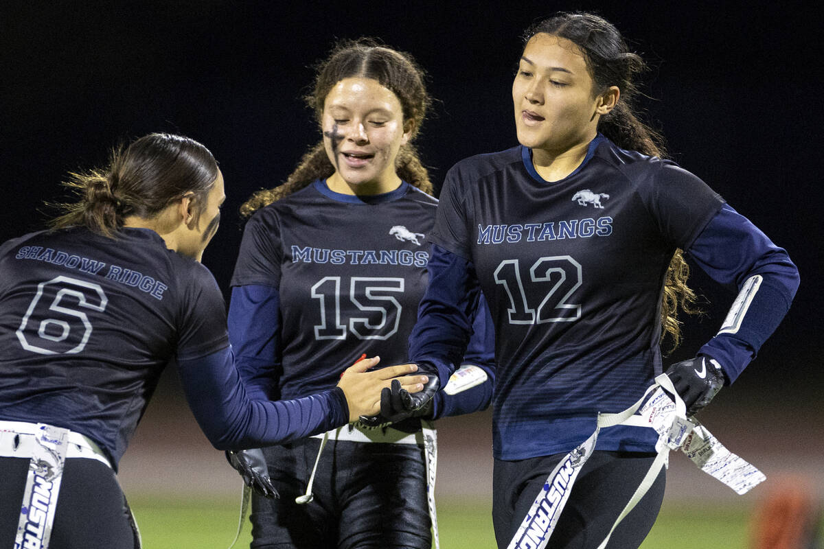 Shadow Ridge junior Jaylani Palmer (12) is welcomed off the field by her teammates during the h ...