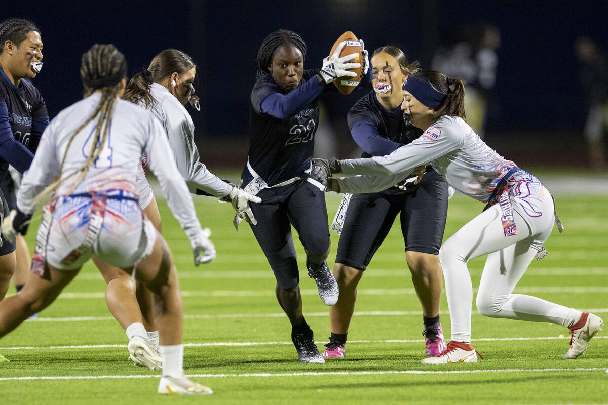 Shadow Ridge senior Savanna McDow (21) runs with the ball during the high school flag football ...