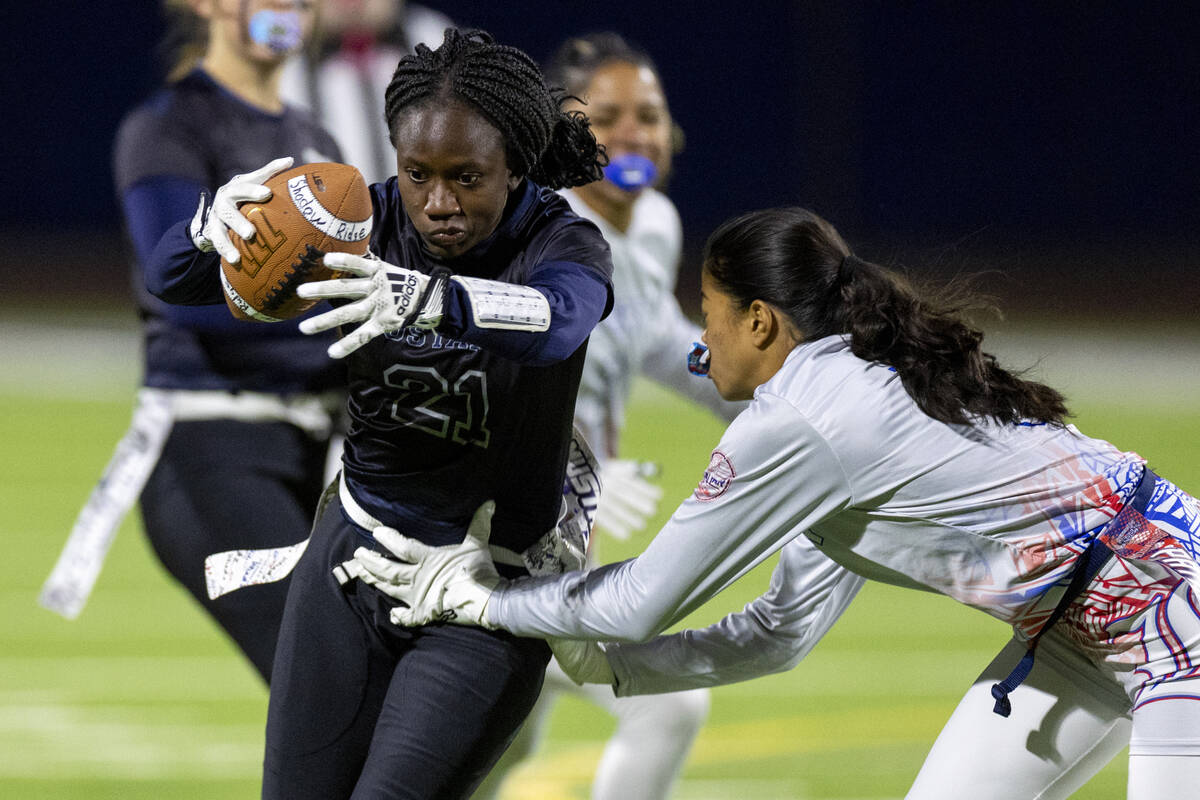 Shadow Ridge senior Savanna McDow (21) attempts to avoid Liberty sophomore Kaily Batoon, right, ...