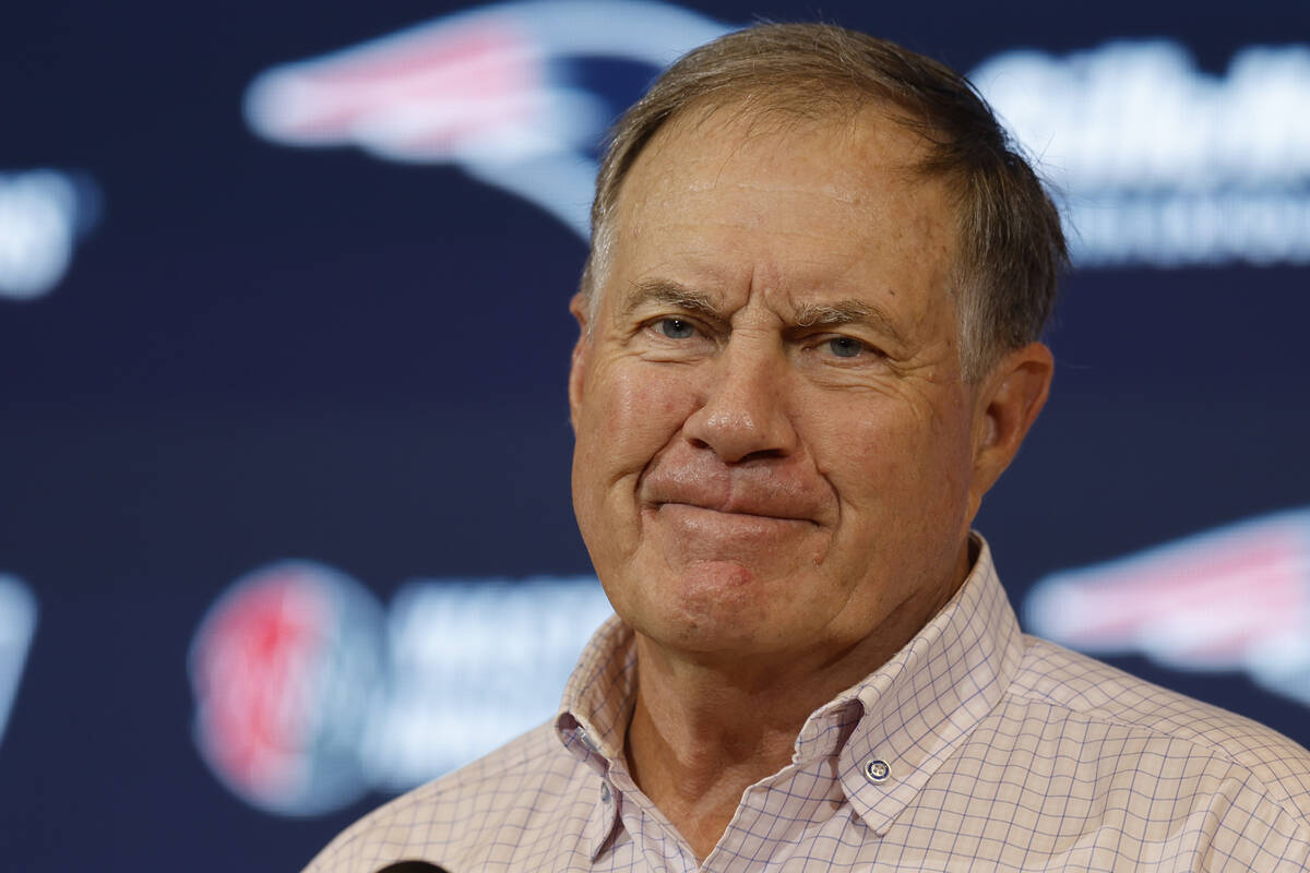 Then-New England Patriots head coach Bill Belichick talks with reporters following an NFL footb ...