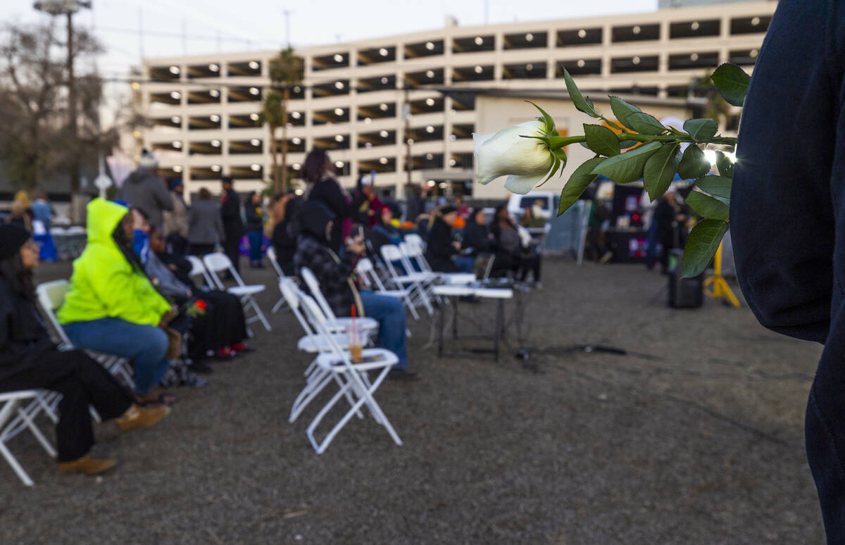 Roses are handed out for remembrance during the 31st Homeless Candlelight Vigil on Thursday, De ...