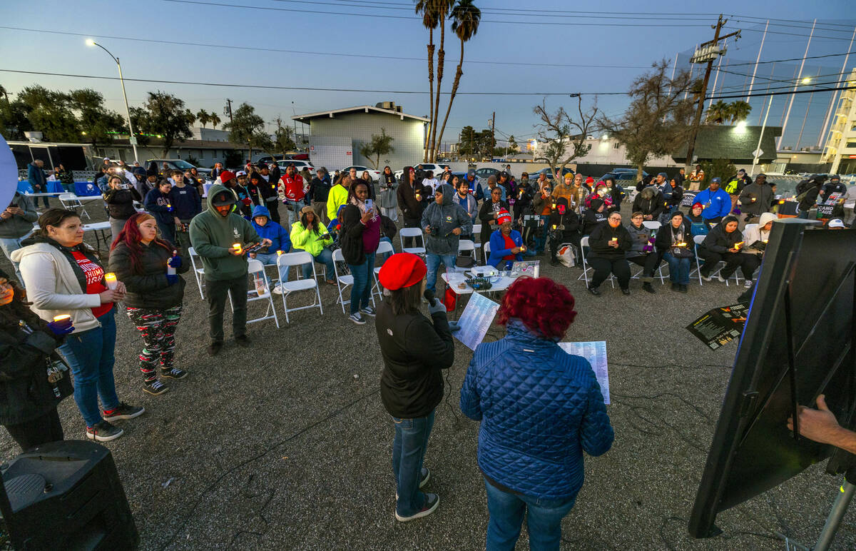 Attendees hold their lit candles as the names of those lost this year a read during the 31st Ho ...