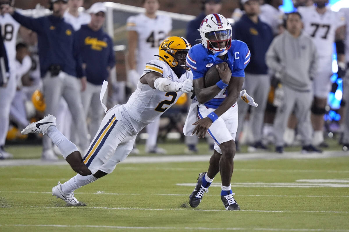 SMU quarterback Kevin Jennings (7) evades California defensive back Craig Woodson (2) during th ...