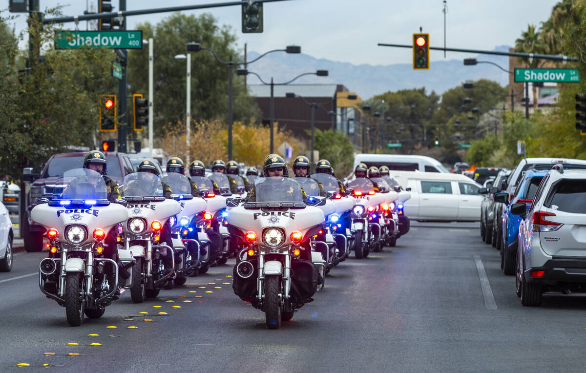 Metropolitan Police motorcycle officers arrive escorting the hearse transporting officer Colton ...