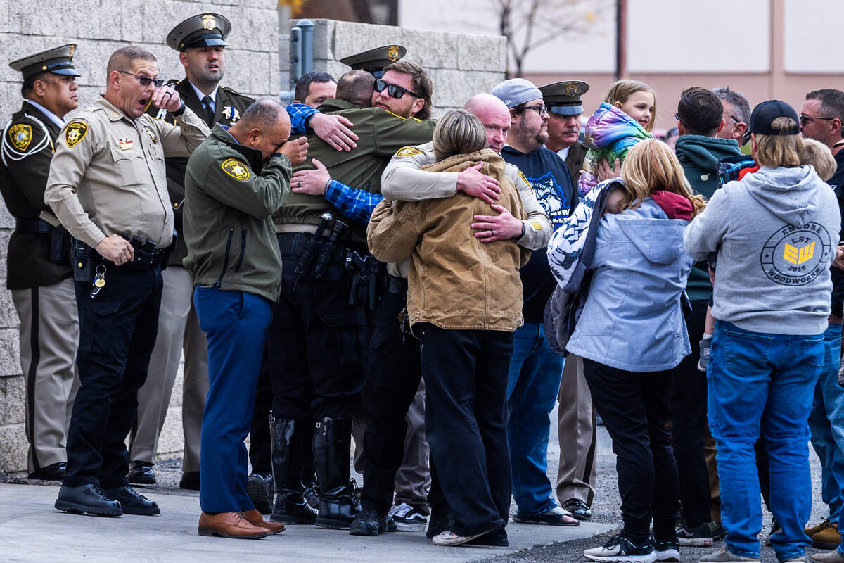 Family and friends are consoled with Metropolitan Police officers and supporters after the arri ...