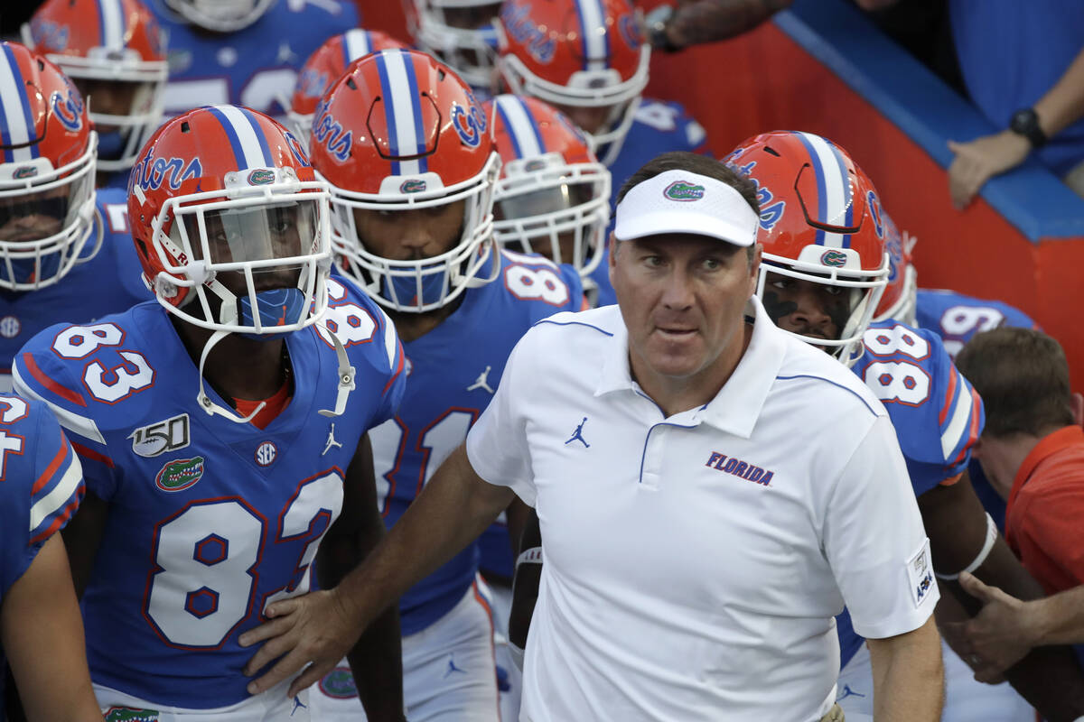 Florida head coach Dan Mullen takes the field with his players before an NCAA college football ...