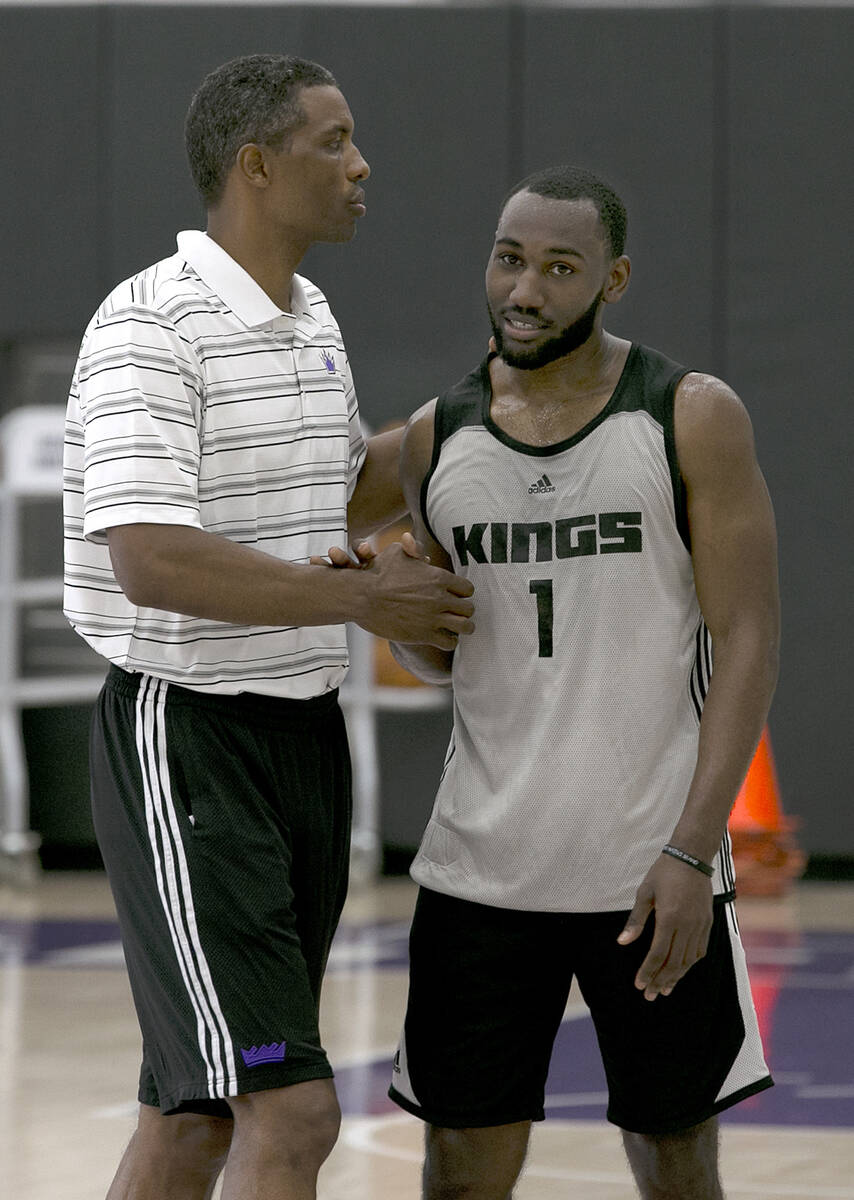 Kentucky guard Dominique Hawkins, right, shakes hands with Larry Lewis, player development coac ...