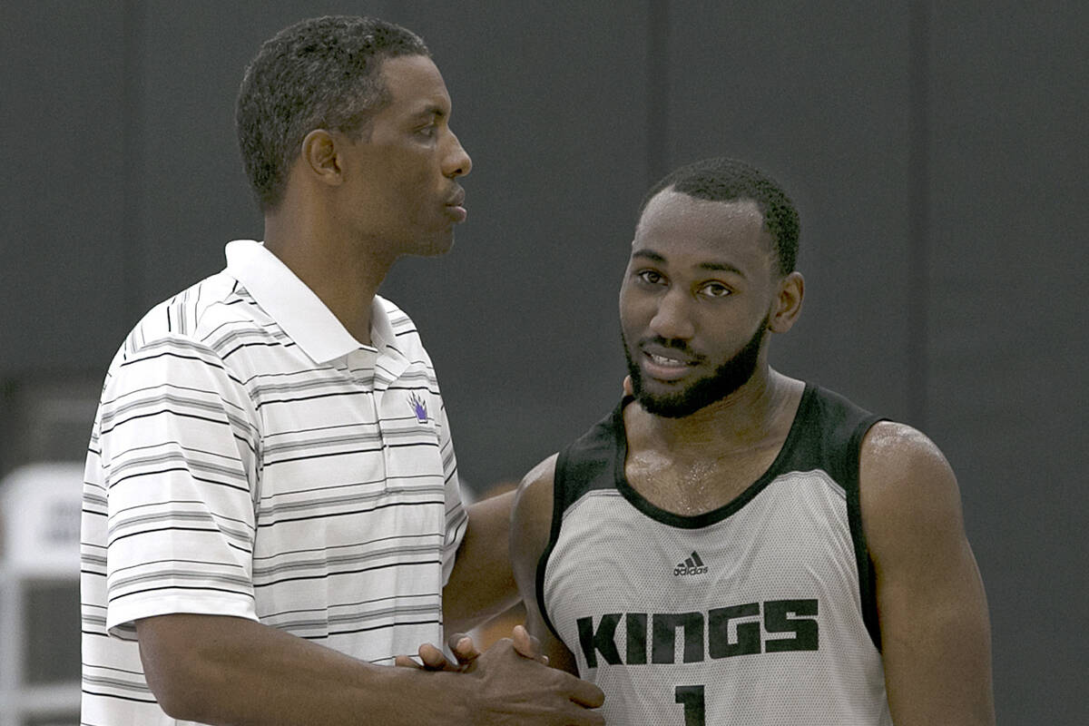 Kentucky guard Dominique Hawkins, right, shakes hands with Larry Lewis, player development coac ...