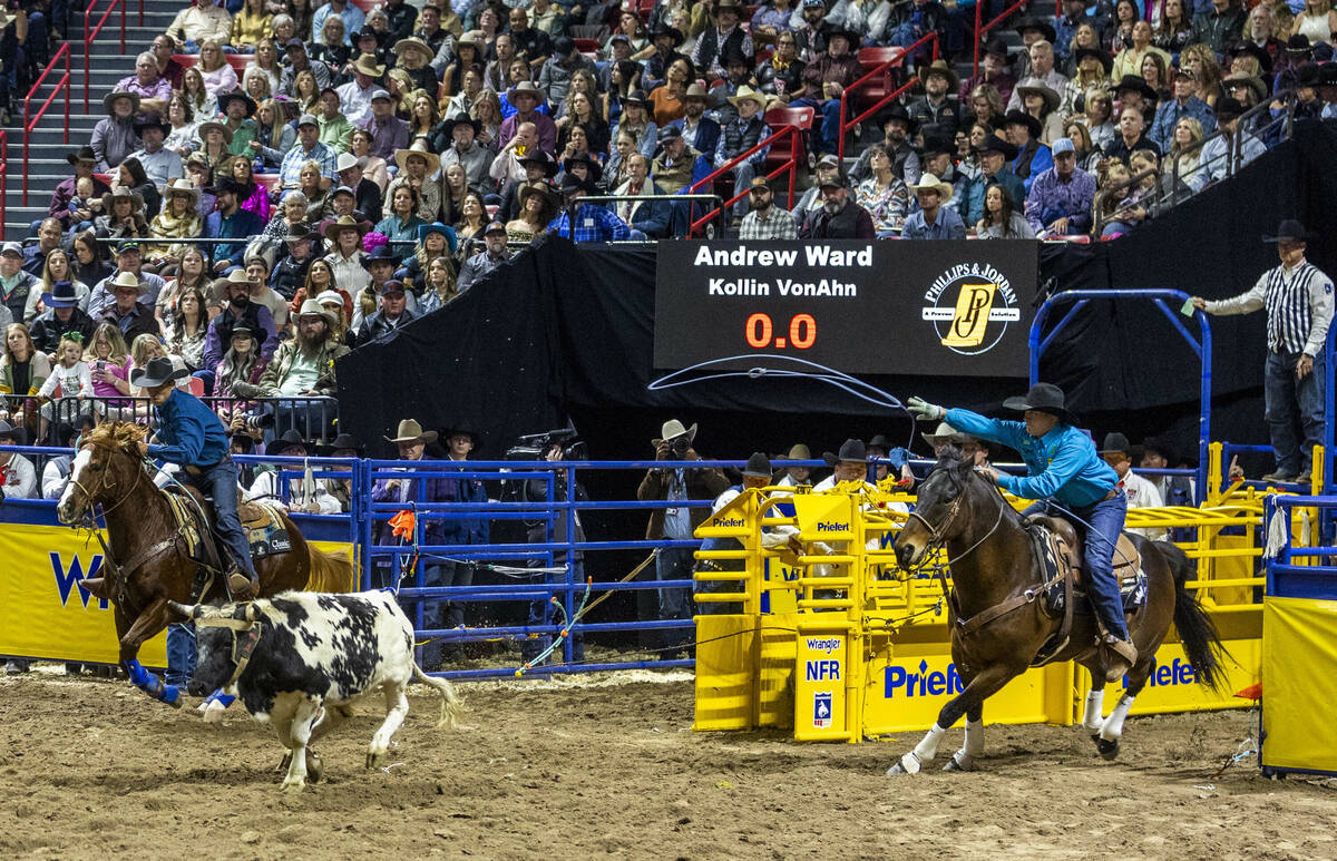 Team Roping header Andrew Ward, right, and heeler Kollin VonAhn work to rope their calf during ...