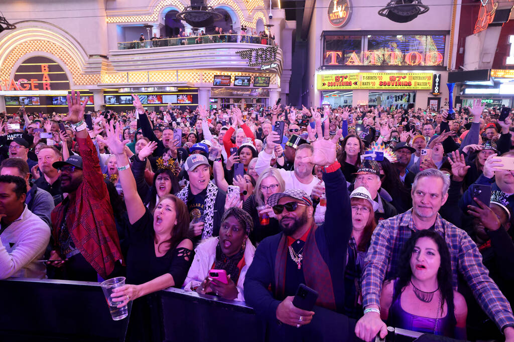 New Year’s Eve revelers listen to Color Me Badd on the First Street Stage during the Time of ...