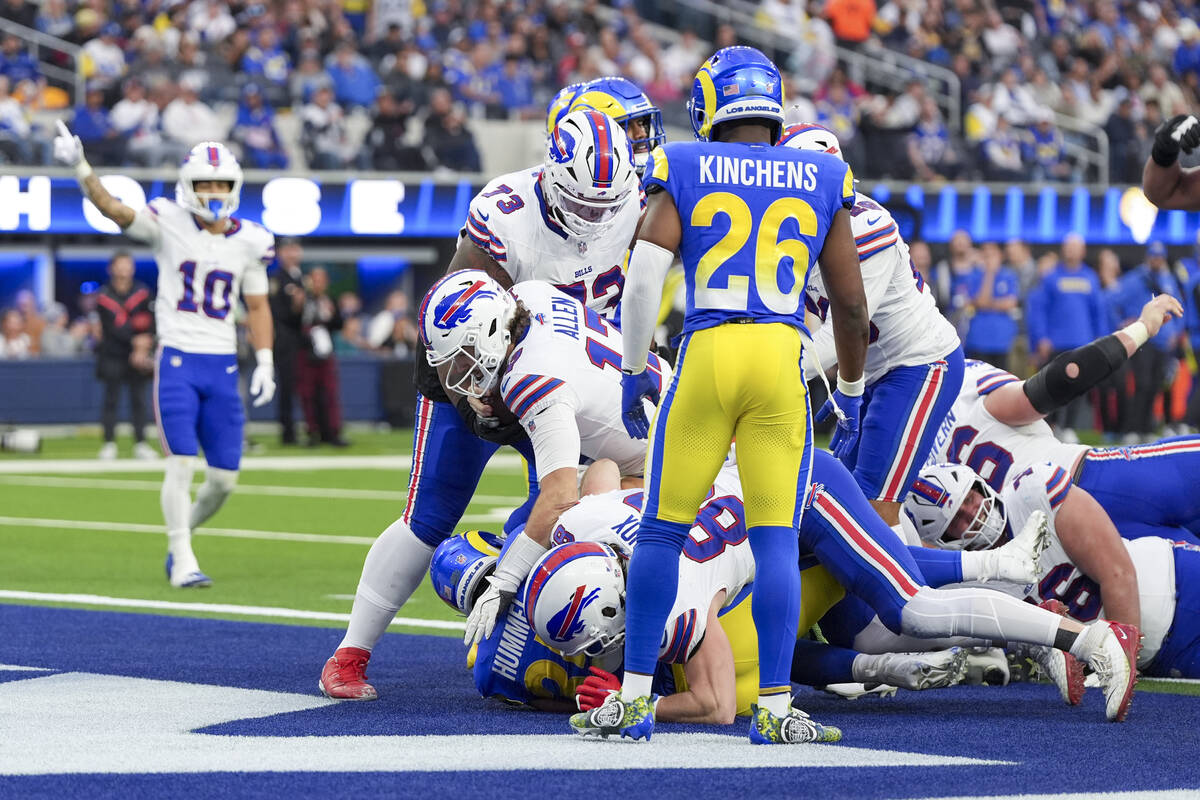 Buffalo Bills quarterback Josh Allen, center, scores a touchdown against the Los Angeles Rams d ...