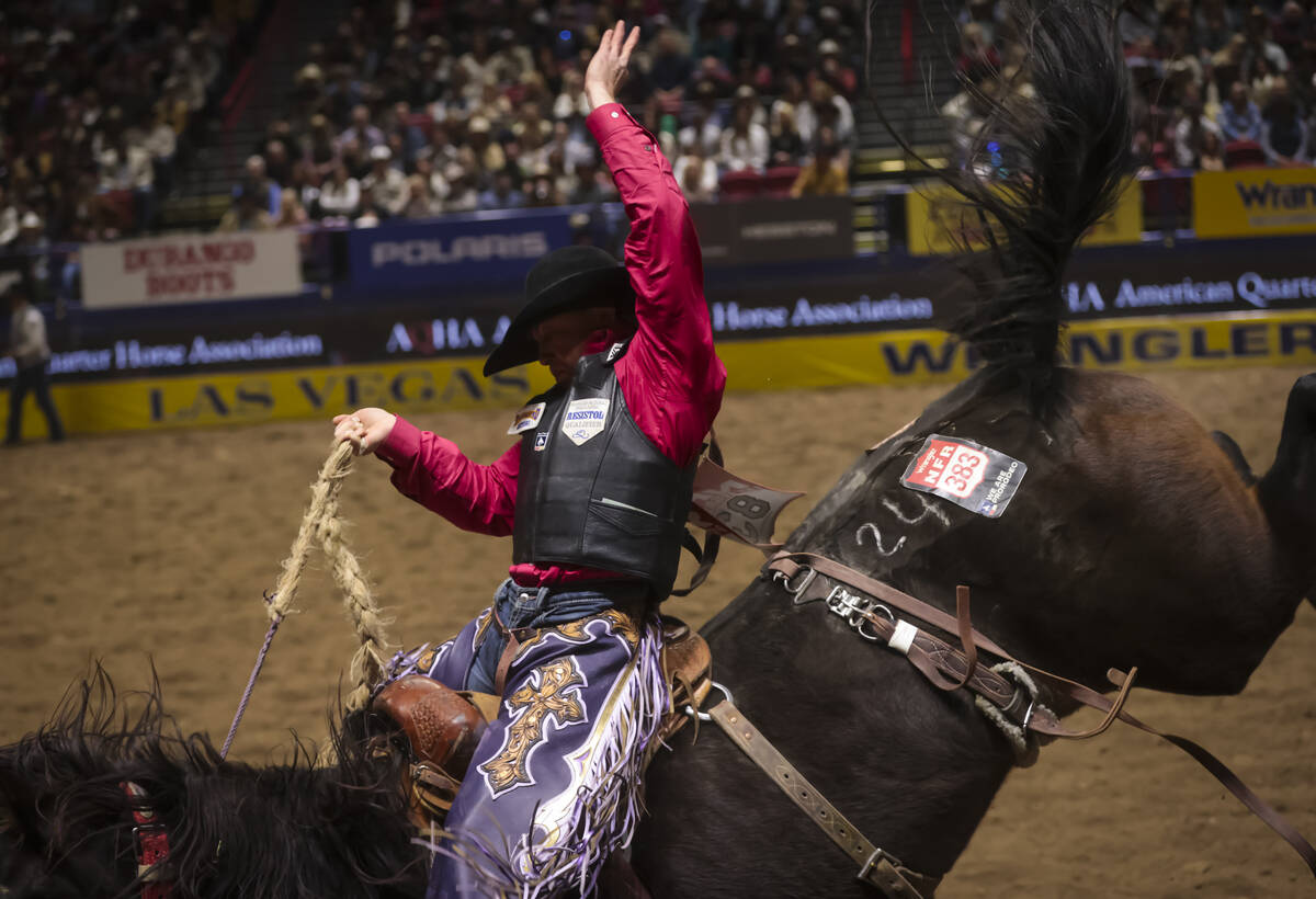 Logan Hay competes in saddle bronc riding during the 8th go-round of the National Finals Rodeo ...