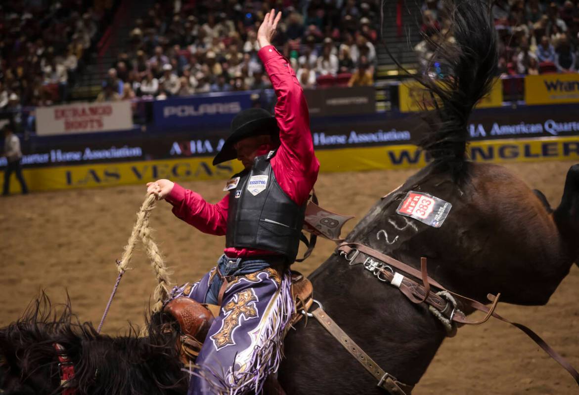 Logan Hay competes in saddle bronc riding during the 8th go-round of the National Finals Rodeo ...