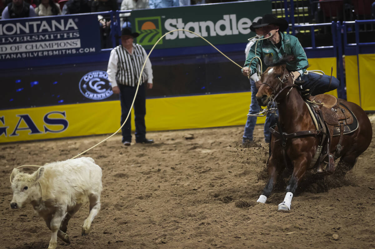 Marty Yates competes in tie-down roping during the 8th go-round of the National Finals Rodeo at ...