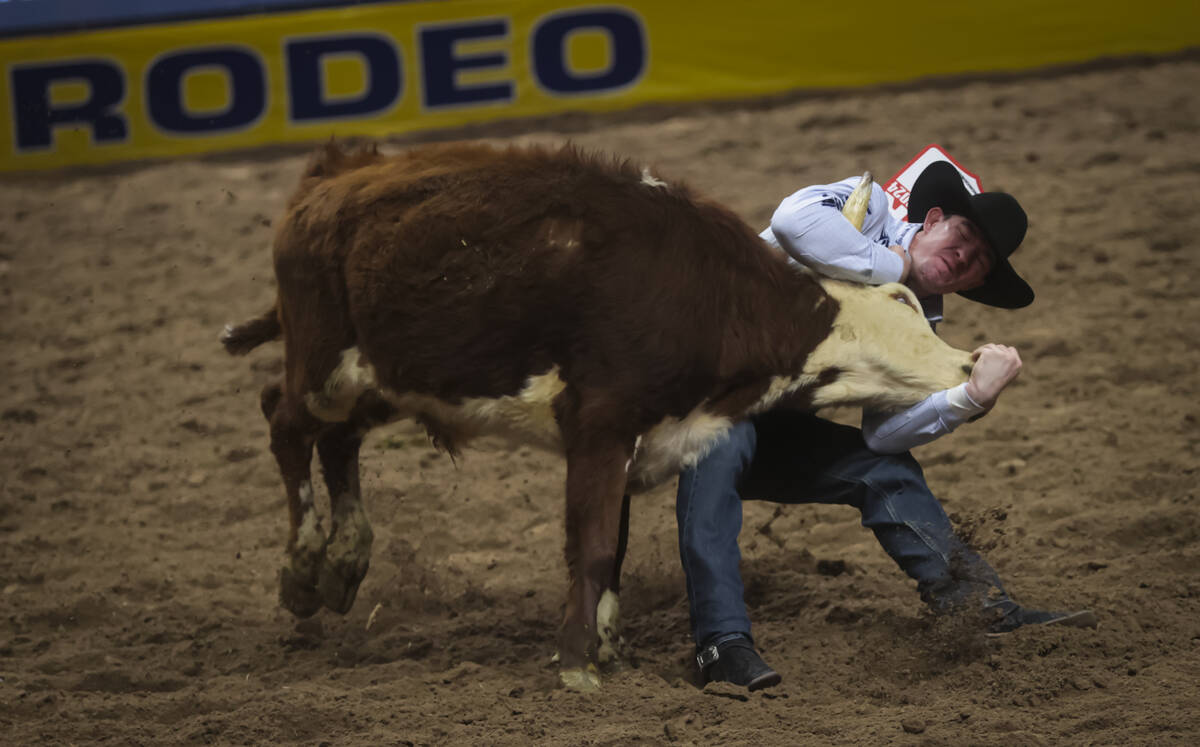 Dalton Massey competes in steer wrestling during the 8th go-round of the National Finals Rodeo ...