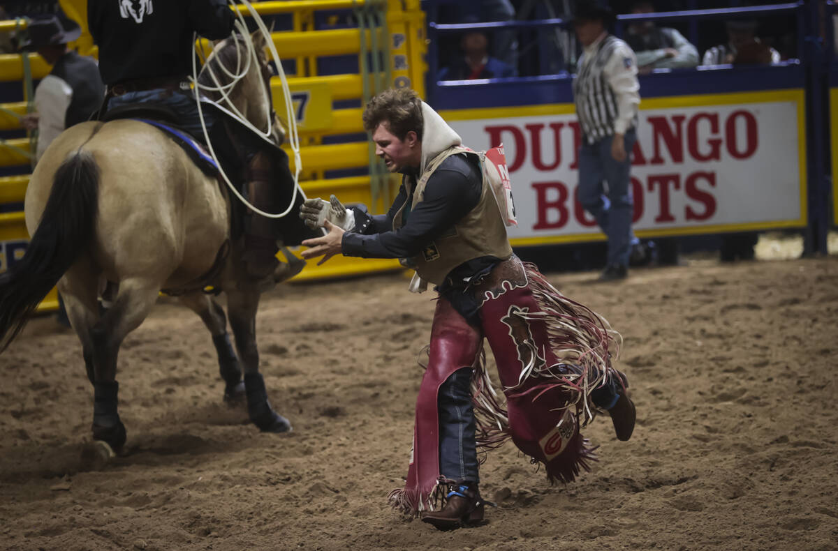 Dean Thompson reacts after competing in bareback riding during the 8th go-round of the National ...