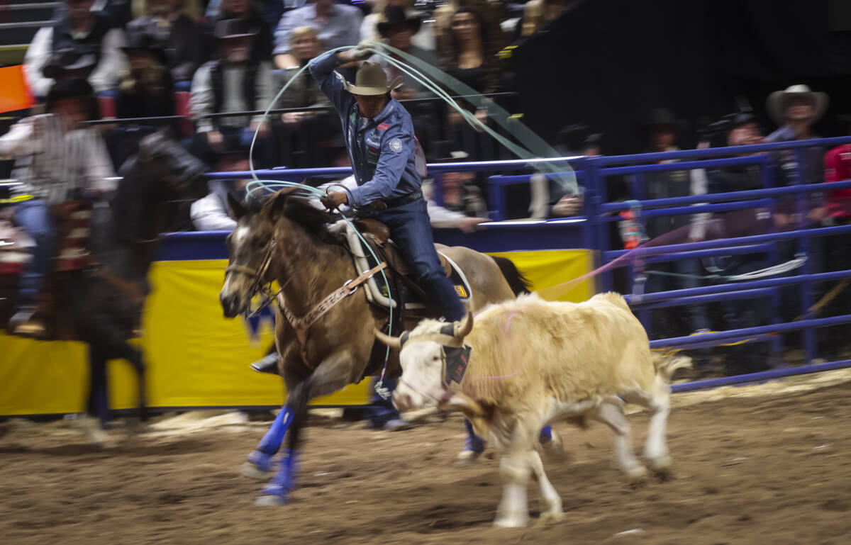 Junior Nogueira and Kaleb Driggers, not pictured, compete in team roping during the 8th go-roun ...