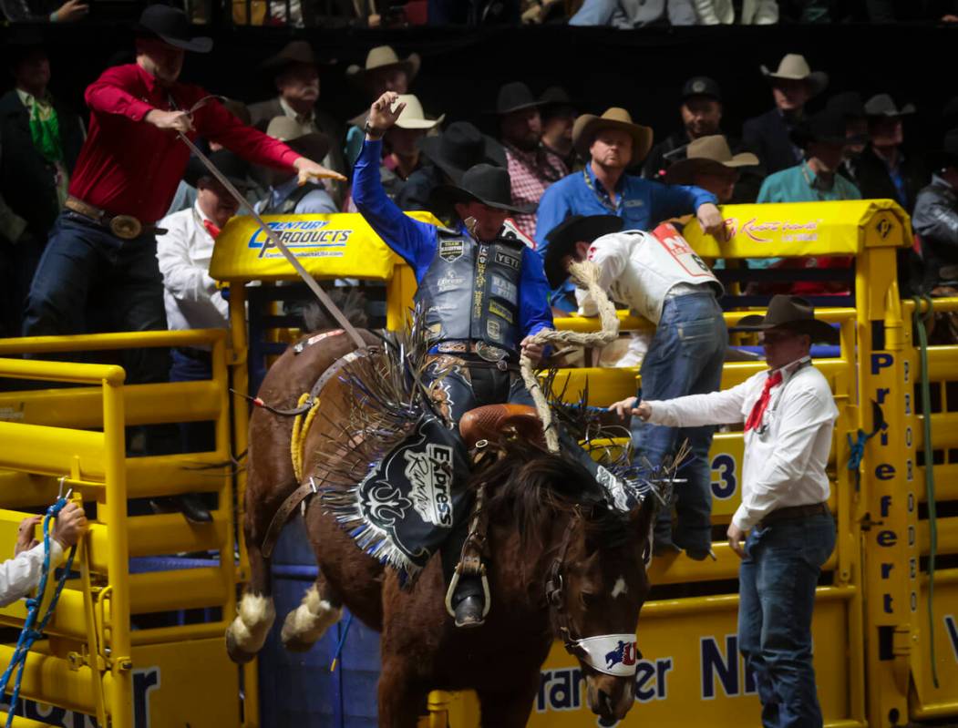 Statler Wright competes in saddle bronc riding during the 8th go-round of the National Finals R ...