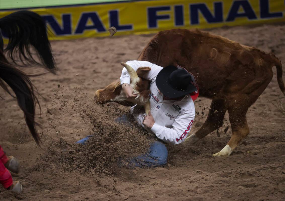 Cash Robb competes in steer wrestling during the 8th go-round of the National Finals Rodeo at t ...