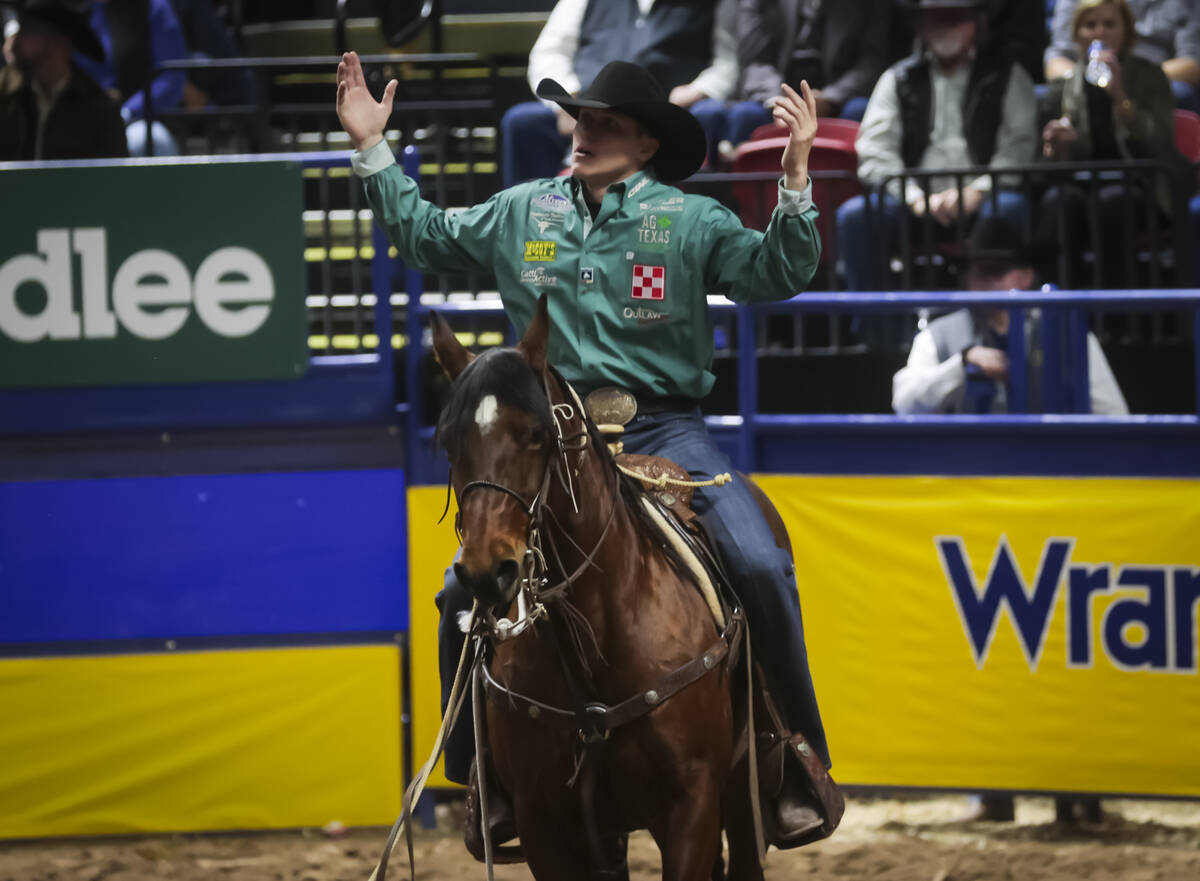 Marty Yates reacts after competing in tie-down roping during the 8th go-round of the National F ...