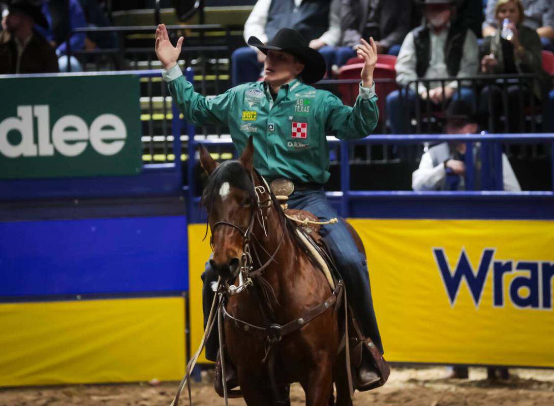 Marty Yates reacts after competing in tie-down roping during the 8th go-round of the National F ...