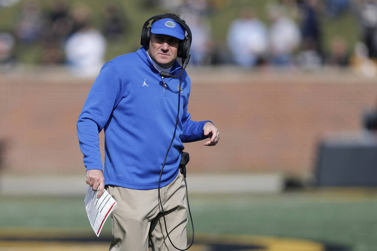 Florida head coach Dan Mullen watches from the sidelines during the first half of an NCAA colle ...