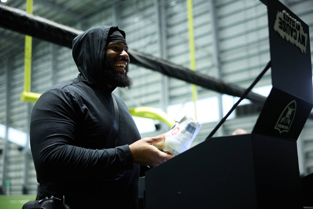 Raiders defensive tackle John Jenkins sees the cleats he will wear on "Monday Night Football" s ...