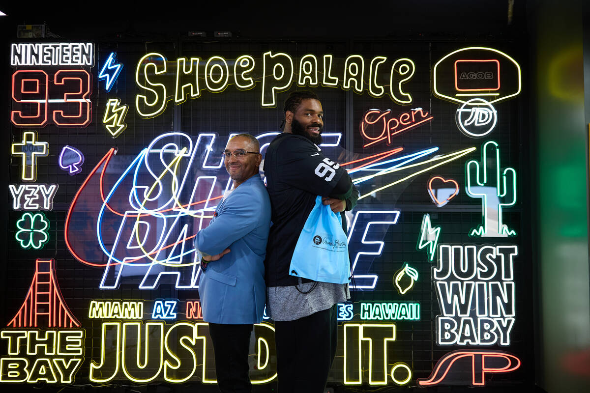 Raiders defensive tackle John Jenkins poses with Reggie Burton. Jenkins will wear cleats highli ...