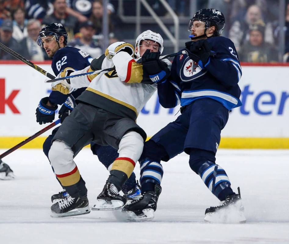 Winnipeg Jets' Mason Appleton (22) defends against Vegas Golden Knights' Victor Olofsson (95) d ...