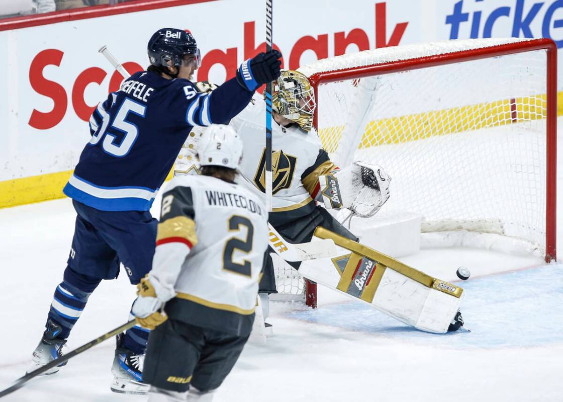 Winnipeg Jets' Mark Scheifele (55) celebrates as Josh Morrissey's (44) shot gets past Vegas Gol ...