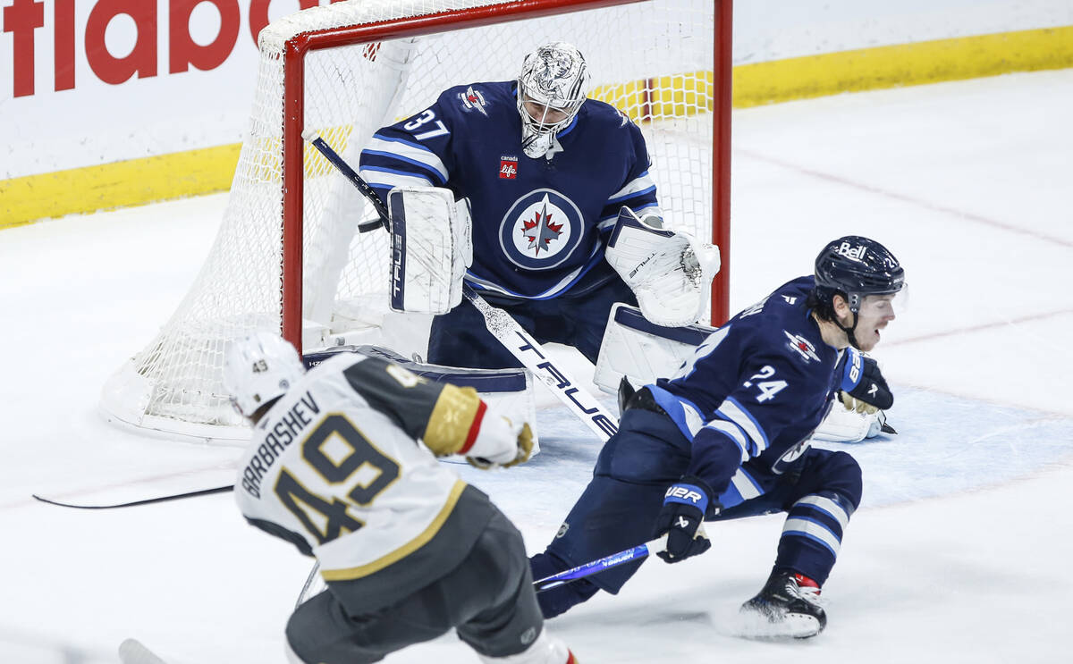 Vegas Golden Knights' Ivan Barbashev (49) scores the overtime winning goal against Winnipeg Jet ...