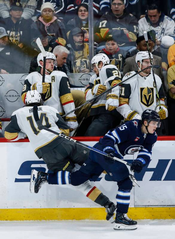 Winnipeg Jets' Rasmus Kupari (15) and Vegas Golden Knights' Nicolas Hague (14) collide during t ...