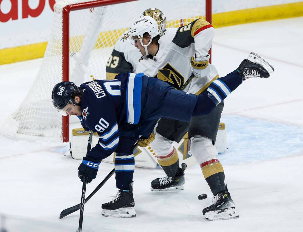 Vegas Golden Knights' Zach Whitecloud (2) defends against Winnipeg Jets' Nikita Chibrikov (90) ...