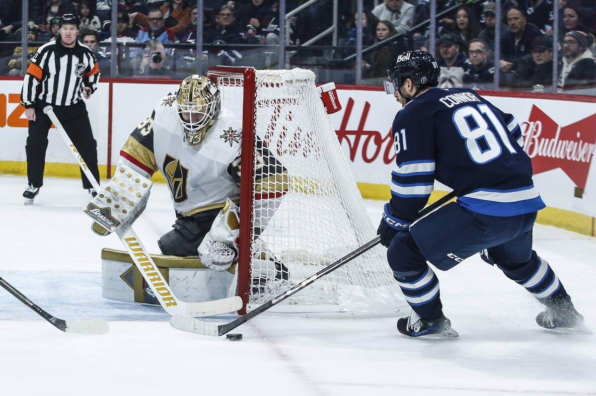 Vegas Golden Knights goaltender Adin Hill (33) covers the angle against Winnipeg Jets' Kyle Con ...