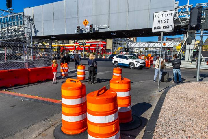 Pedestrians navigate barricades and other race barriers along Koval Lane at the Flamingo Road b ...