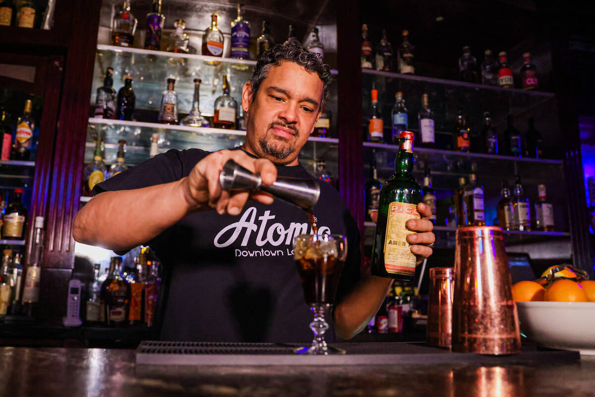 Dean Howard, a bartender, makes a glass of Picon Punch at Atomic Liquors on Dec. 12, 2024, in L ...