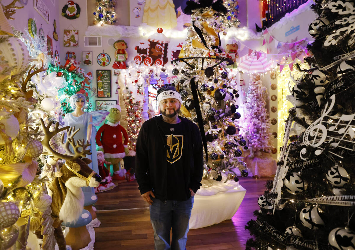 Joey Cardona poses for a photo, surrounded by the extravagant Christmas decorating, at his and ...