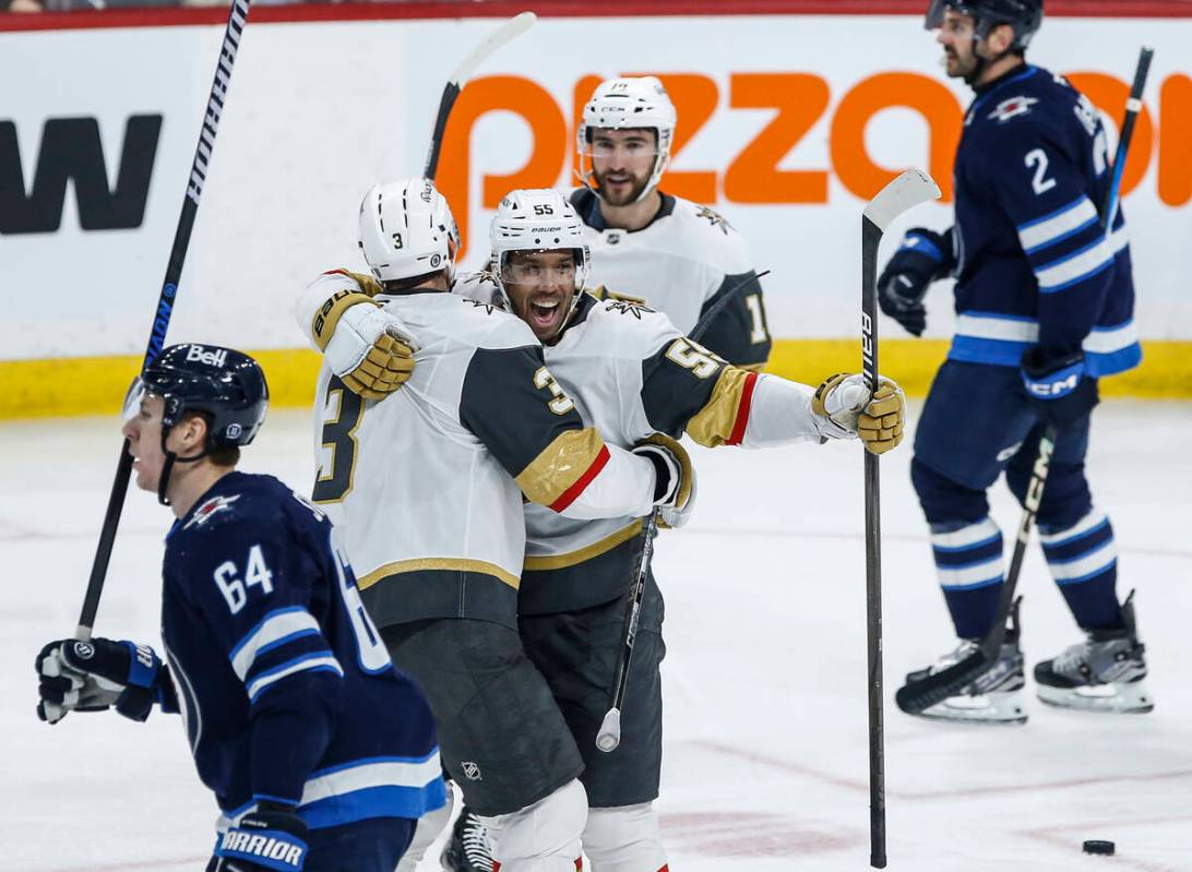 Vegas Golden Knights' Brayden McNabb (3) and Keegan Kolesar (55) celebrate Lolesar's goal again ...