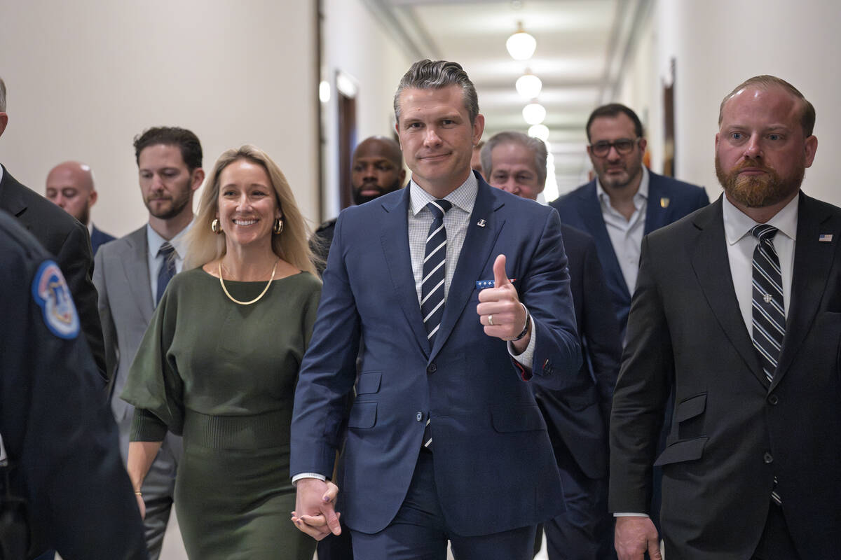 Pete Hegseth, President-elect Donald Trump's nominee to be Defense Secretary, gives a thumbs-up ...