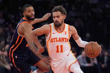 Atlanta Hawks' Trae Young (11) drives past New York Knicks' Mikal Bridges during the first half ...