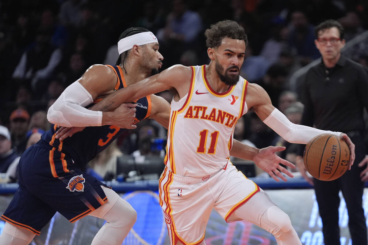 Atlanta Hawks' Trae Young (11) drives past New York Knicks' Josh Hart (3) during the first half ...