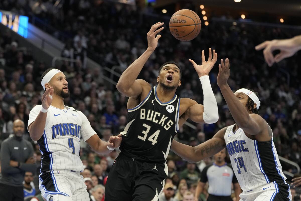 Milwaukee Bucks' Giannis Antetokounmpo goes after a loose ball with Orlando Magic's Wendell Car ...