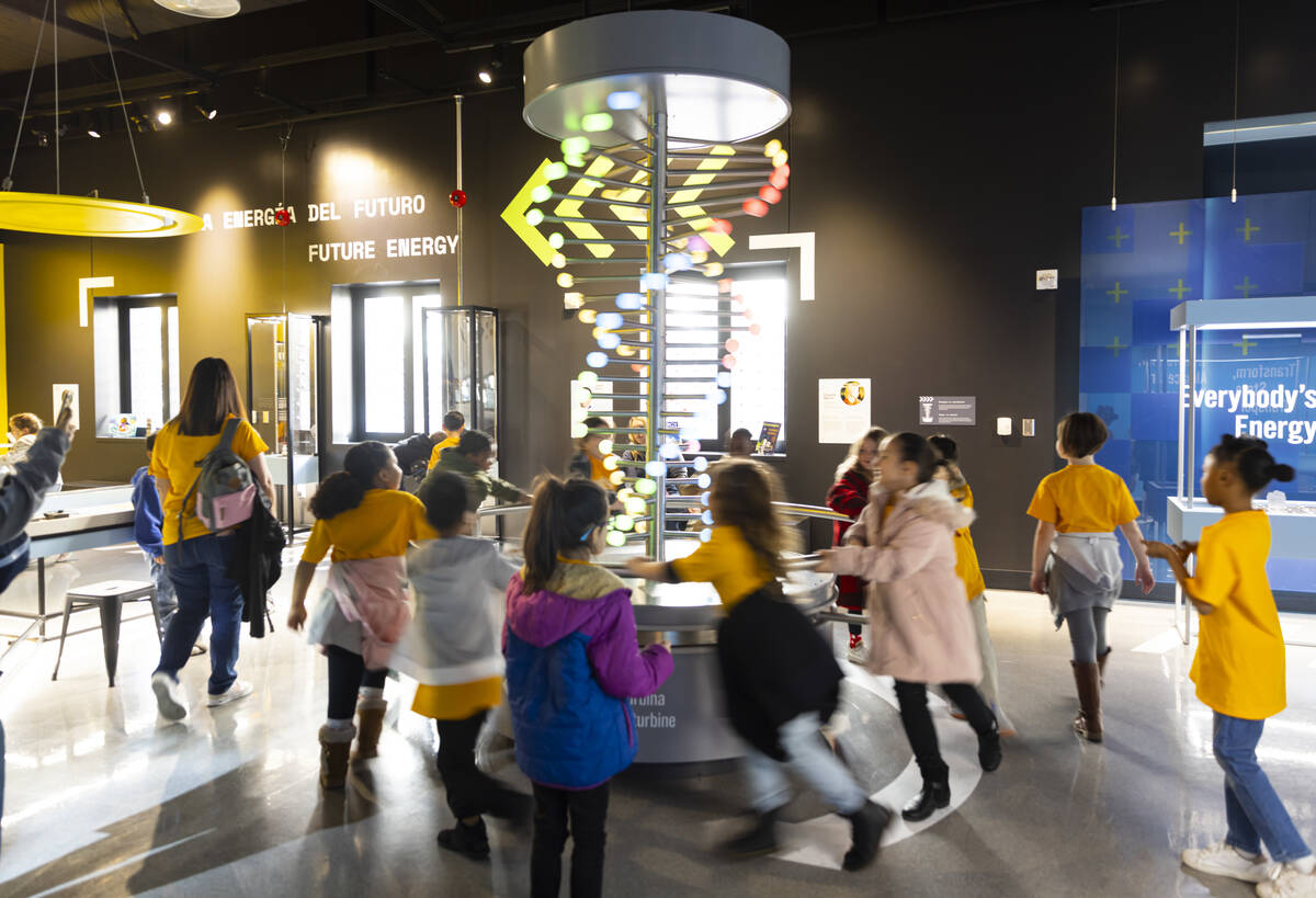 Children run around to simulate the use of a wind turbine during a tour of the Discovery Childr ...