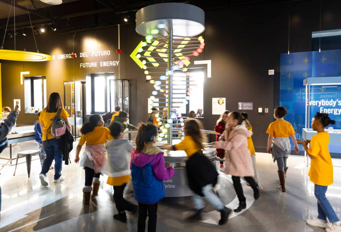 Children run around to simulate the use of a wind turbine during a tour of the Discovery Childr ...