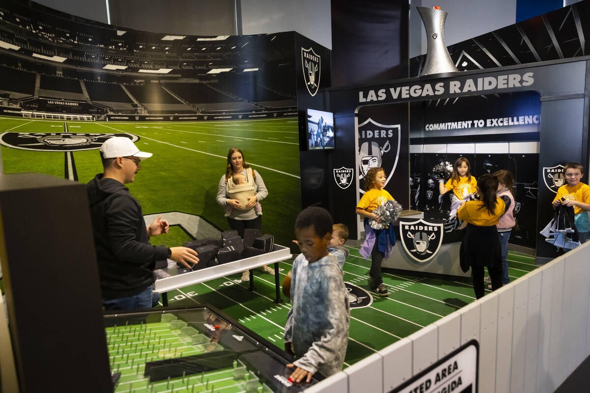 People explore a Raiders themed area in the eco city area during a tour of the Discovery Childr ...