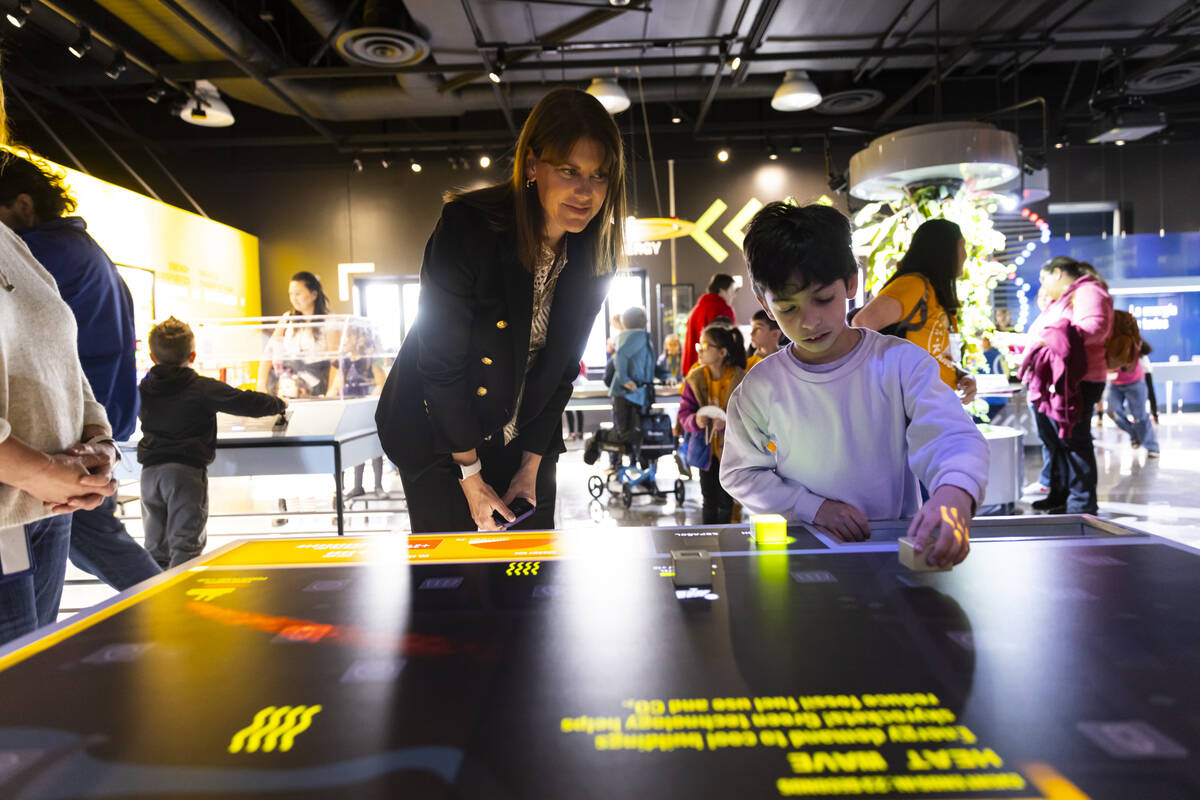 Melissa Kaiser, CEO of Discovery Children’s Museum, helps guide a visitor with an intera ...