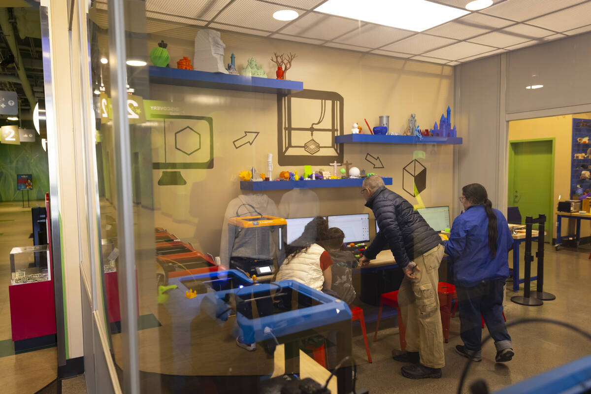 A family checks out a 3D printer during a tour of the Discovery Children’s Museum on Tue ...