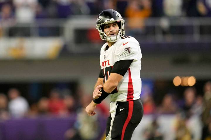 Atlanta Falcons quarterback Kirk Cousins walks off the field after throwing an interception dur ...