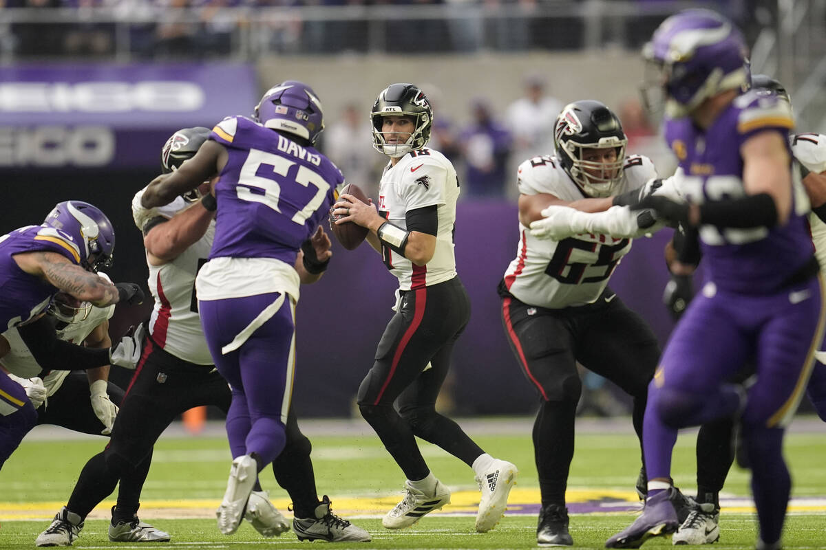 Atlanta Falcons quarterback Kirk Cousins (18) looks to pass during the first half of an NFL foo ...